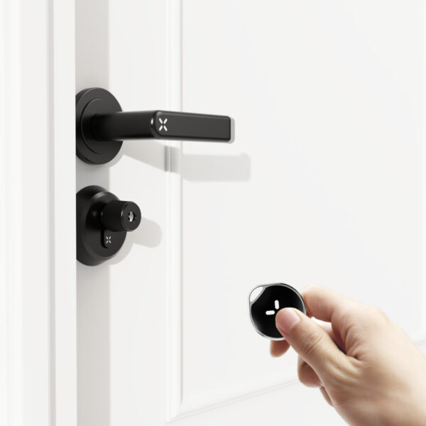 Black circular smart key fob with a white X-shaped button design, featuring a keyring loop at the top.
